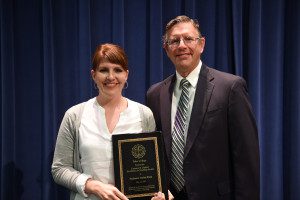 Professor Carisa Funk receives the Clarence R. Hiebert Excellence in Teaching Award from Dr. Frank Johnson.