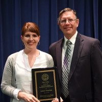 Professor Carisa Funk receives the Clarence R. Hiebert Excellence in Teaching Award from Dr. Frank Johnson