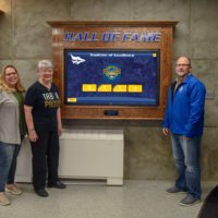 Wiebe Family stands next to the Hall of Fame Experience