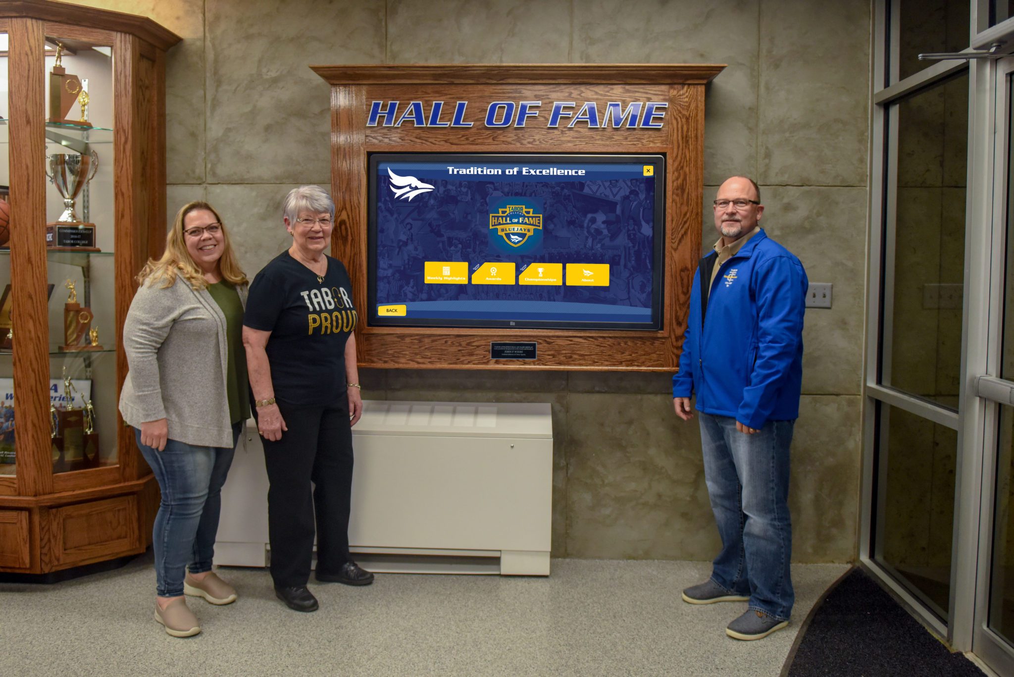 Wiebe Family stands next to the Hall of Fame Experience