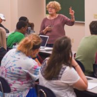 professor teaching students in classroom