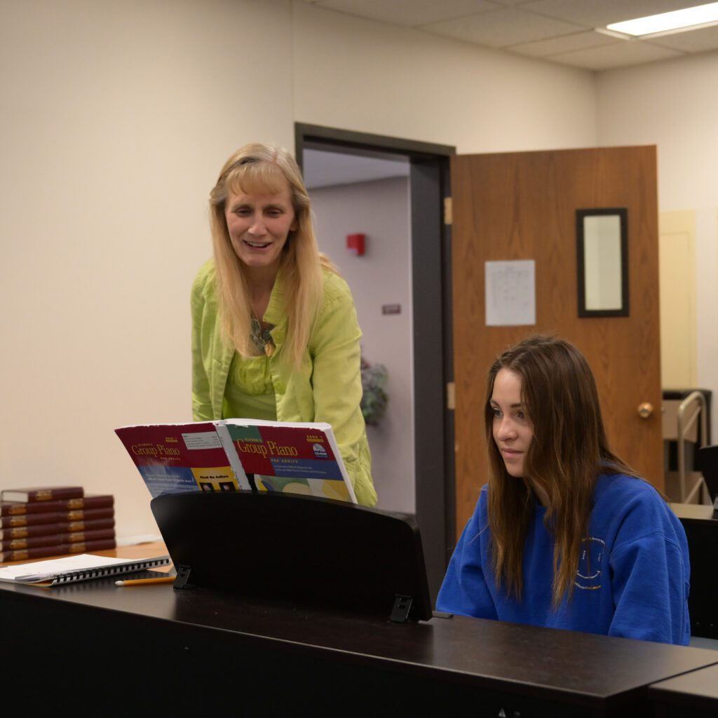 Dr. Sheila Litke and student practicing piano