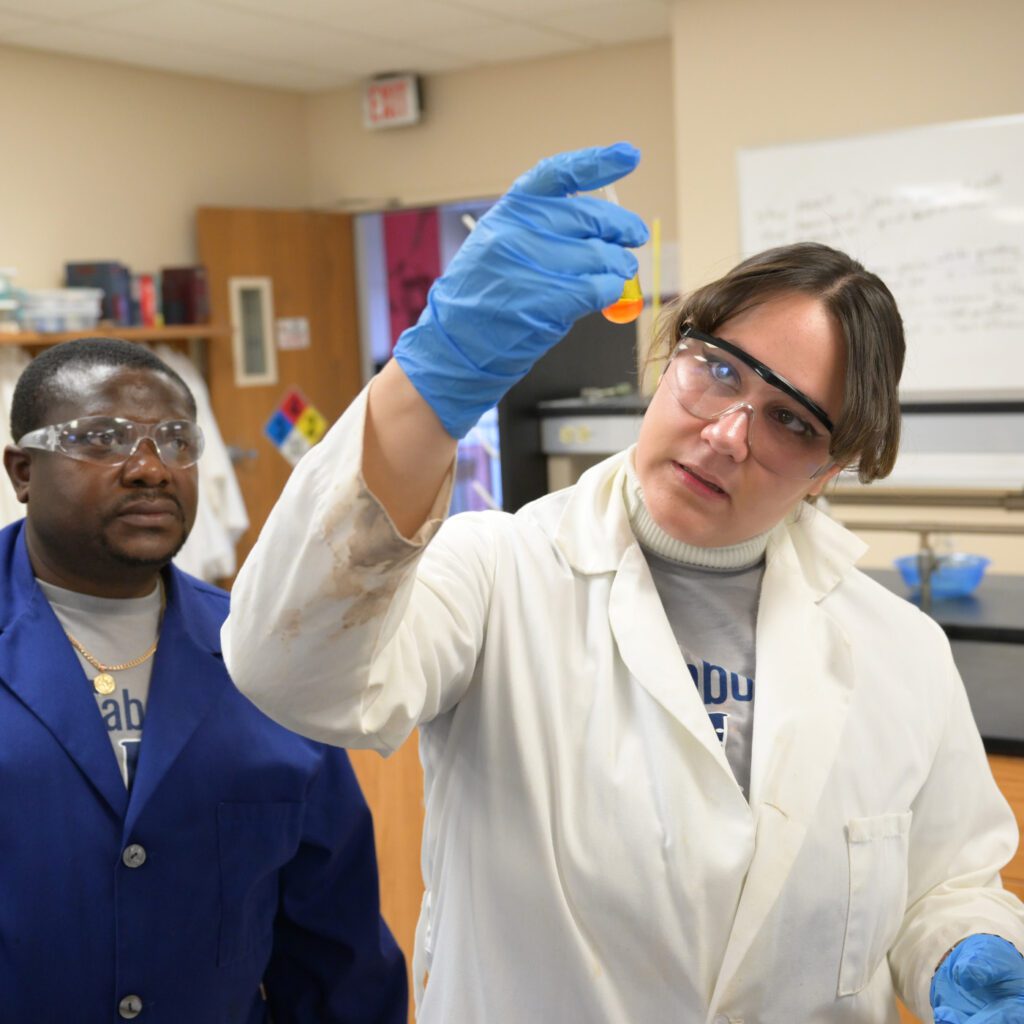 Riley Collins and Dr. James Titah in the lab 