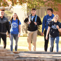 Students walking on Tabor campus on a web banner