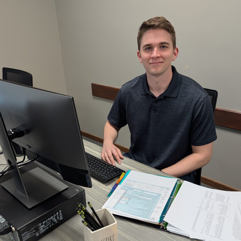 Tabor student Jonah Arrasmith posing at desk