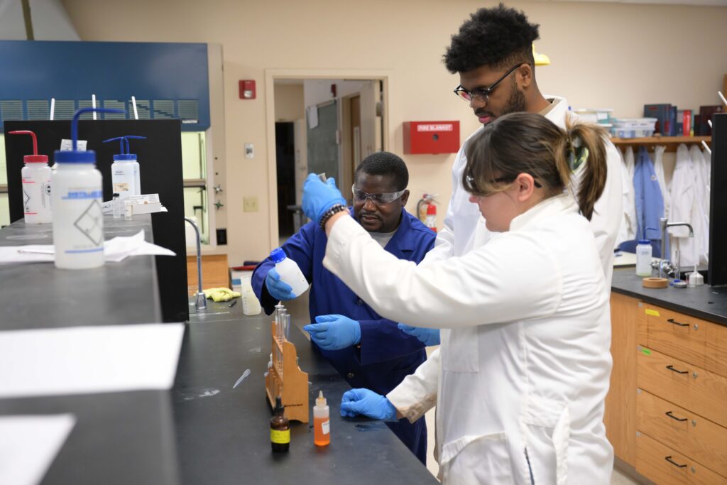Tabor students in chemistry lab with professor