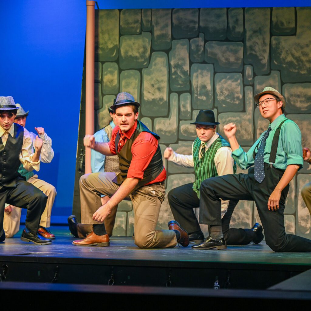 Guys & Dolls photo call with students dancing & performing on stage