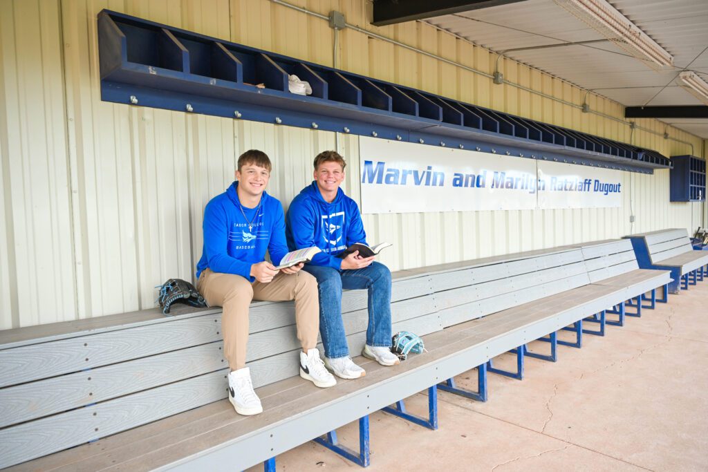 Dellen Claassen and Brayden Berens in baseball dugout for photo about baseball Bible study