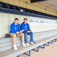 Dellen Claassen and Brayden Berens in baseball dugout for photo about baseball Bible study