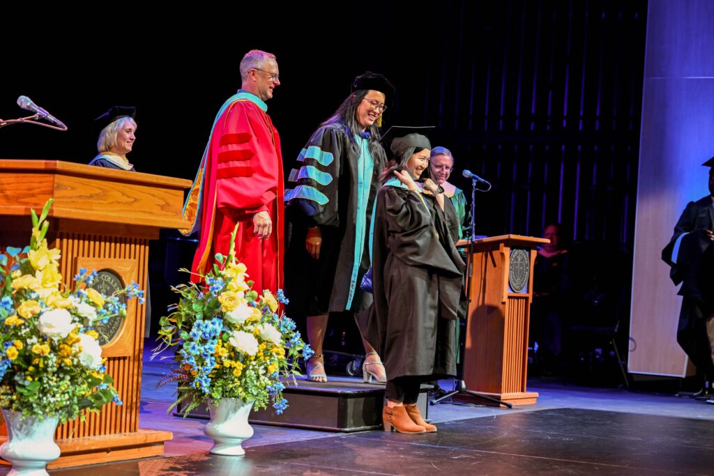 Tabor graduate receives hooding at M.Ed. graduation ceremony