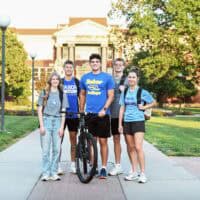Tabor students pose by Centennial Plaza for photo for marketing
