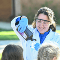 Riley Collins science demonstration with elementary school students